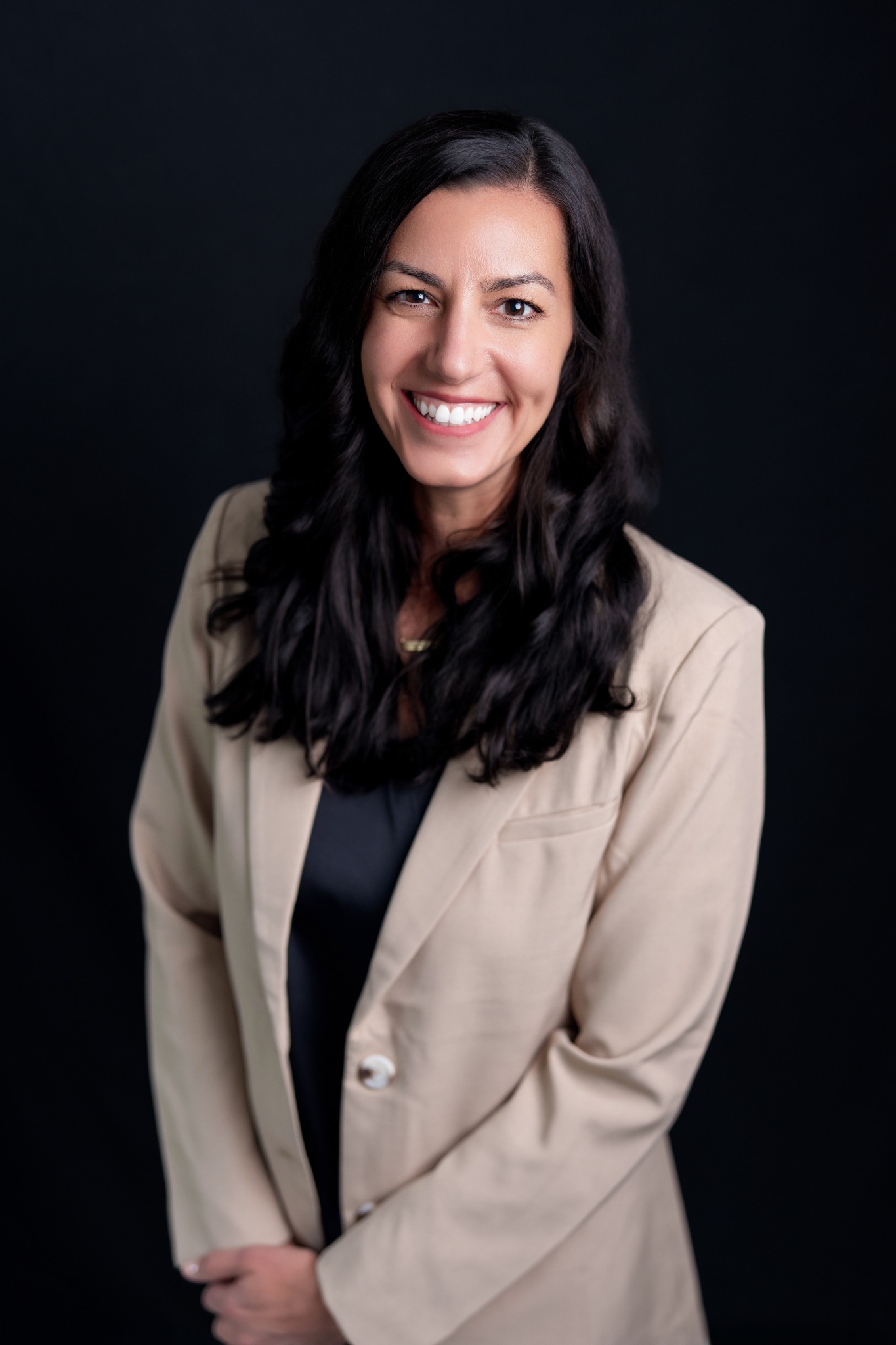 Professional studio headshot with a dark background